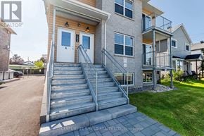 Cornwall triplex for rent - A modern two-story house with a staircase leading to the front door.