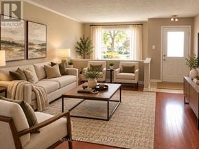 Ottawa townhouse for rent - A well-lit living room with a large couch, a coffee table, and a view of the outdoors through the window.