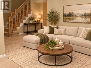 Ottawa townhouse for rent - A living room with a couch, coffee table, and a painting on the wall.