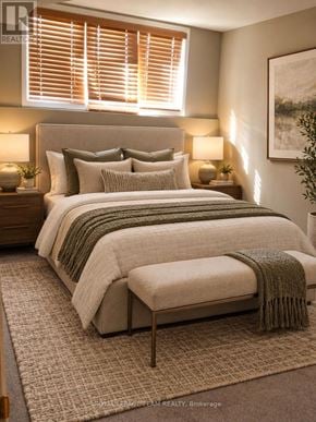Ottawa townhouse for rent - A bedroom with a large bed and a green throw blanket.