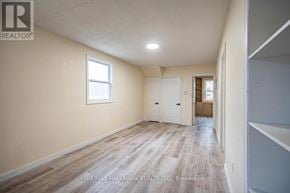 London East (East K) duplex for rent - A room with wooden flooring and white walls, with a window on the left wall.