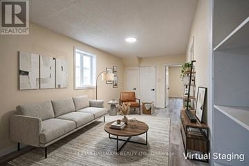 London East (East K) duplex for rent - A living room with a grey couch and a coffee table.