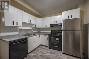 London East (East K) duplex for rent - A kitchen with white cabinets and stainless steel appliances.