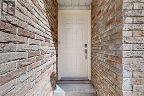 Brampton (Fletcher's West) apartment for rent - A white door is set in a brick wall.
