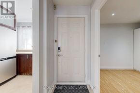 Brampton (Fletcher's West) apartment for rent - A white door is in the middle of a room with a wooden floor.