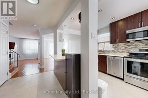Brampton (Fletcher's West) apartment for rent - A modern kitchen with stainless steel appliances and wooden cabinets.
