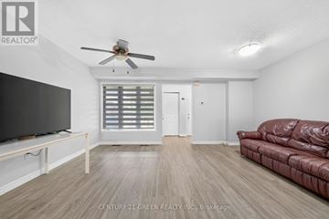 Kitchener townhouse for rent - A living room with a brown leather couch and a flat screen TV.
