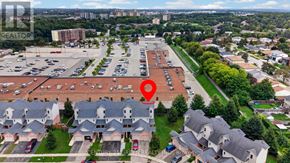 Kitchener townhouse for rent - An aerial view of a parking lot with a red marker indicating a specific area.