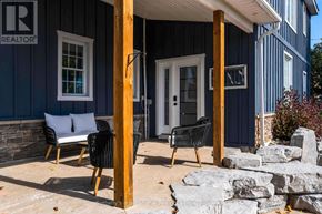 Collingwood apartment for rent - A blue house with a porch and a sign that says REALTOR.