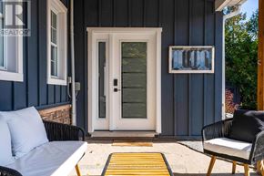 Collingwood apartment for rent - A white door is on the left side of a blue house.