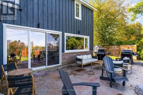 Collingwood apartment for rent - A patio with a table and chairs is shown in front of a house.