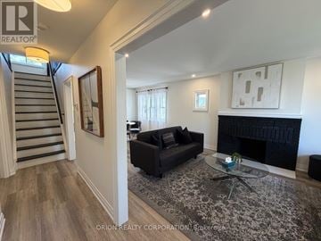 Mississauga (Lakeview) apartment for rent - A living room with a black couch and a fireplace.
