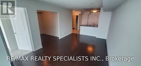 Toronto (Islington-City Centre West) condo for rent - A room with a white door and a brown floor.