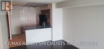 Toronto (Islington-City Centre West) condo for rent - A room with a kitchen island and a refrigerator in it.