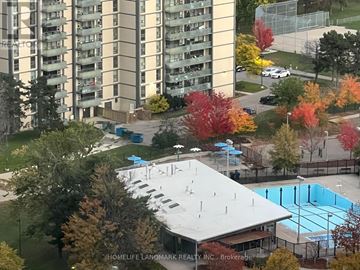 Toronto (Henry Farm) condo for rent - A large apartment complex with a pool and a playground.