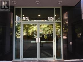 Toronto (Willowdale West) condo for rent - The entrance to a building with glass doors and numbers 5508 and 5500 on the glass.