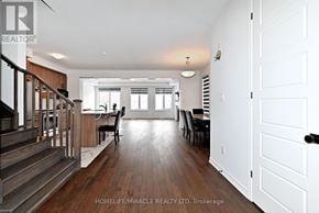 Innisfil apartment for rent - A spacious home interior with a staircase on the left and a dining area in the center.