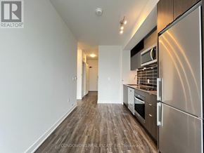Toronto (Waterfront Communities) condo for rent - A kitchen with stainless steel appliances and wooden flooring.