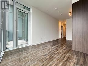 Toronto (Waterfront Communities) condo for rent - A room with wood flooring and a sliding glass door.