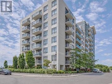Toronto (Dovercourt-Wallace Emerson-Junction) condo for rent - A tall residential building with balconies and a car parked in front.