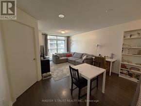 Toronto (Dovercourt-Wallace Emerson-Junction) condo for rent - A living room with a white table and a black chair.
