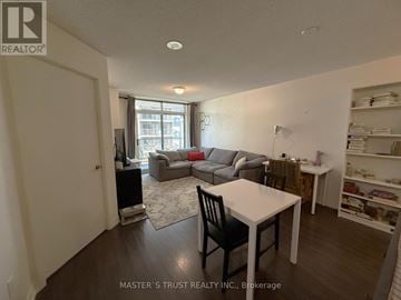 Toronto (Dovercourt-Wallace Emerson-Junction) condo for rent - A living room with a white table and a black chair.