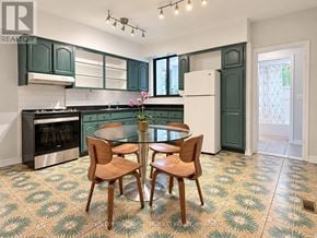 Toronto (Dovercourt-Wallace Emerson-Junction) apartment for rent - A kitchen with green cabinets and a patterned floor.