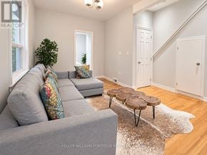 Toronto (Dovercourt-Wallace Emerson-Junction) apartment for rent - A living room with a grey couch and a round coffee table.