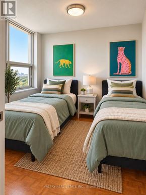 Toronto (Crescent Town) condo for rent - A bedroom with two beds and a painting of a giraffe on the wall.