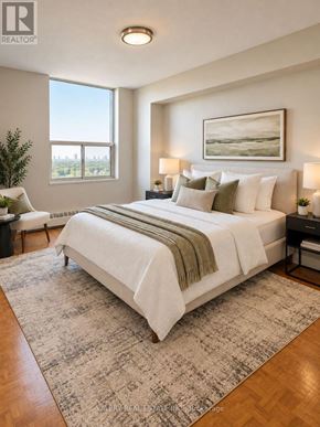 Toronto (Crescent Town) condo for rent - A bedroom with a large bed and a painting on the wall.