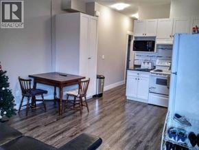 Burnaby apartment for rent - A kitchen with a table and chairs in front of a Christmas tree.