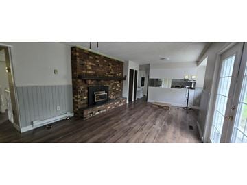 Surrey apartment for rent - A room with a fireplace and wooden floors.