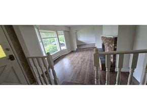 Surrey apartment for rent - A white staircase with a wooden handrail leads to a second floor.