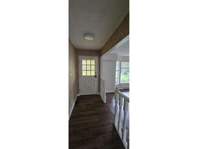 Surrey apartment for rent - A hallway with a white door and a window.