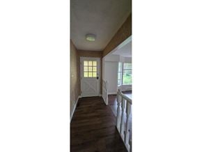 Surrey apartment for rent - A hallway with a white door and a window.