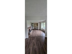 Surrey apartment for rent - A room with wooden floors and white walls.