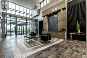 Brampton (Goreway Drive Corridor) condo for rent - A lobby with a bench and a table with a vase on it.