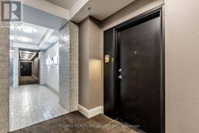 Brampton (Goreway Drive Corridor) condo for rent - A hallway with a black door and a wall of windows.