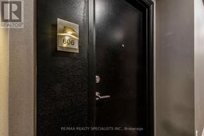 Brampton (Goreway Drive Corridor) condo for rent - A black door with a silver handle and a sign that says RE/MAX REALTY SPECIALISTS INC. Brokerage.