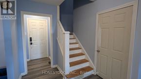 Windsor apartment for rent - A hallway with a white door and a staircase.