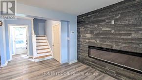 Windsor apartment for rent - A room with a wooden floor and a fireplace.