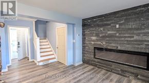 Windsor apartment for rent - A living room with a fireplace and a staircase.