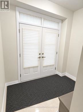 Thorold (Rolling Meadows) apartment for rent - A white door with a black mat in front of it.