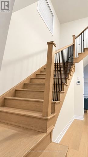 Thorold (Rolling Meadows) apartment for rent - A wooden staircase with a black railing.