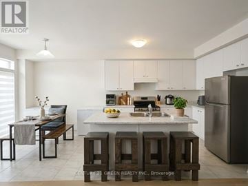 Thorold (Rolling Meadows) apartment for rent - A kitchen with white cabinets and a stainless steel refrigerator.