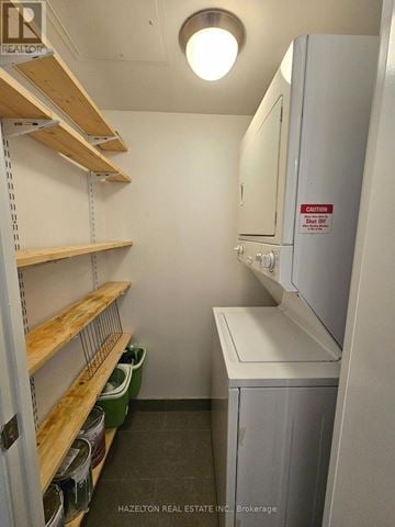 Toronto (Waterfront Communities) condo for rent - A small kitchen with a refrigerator and wooden shelves.
