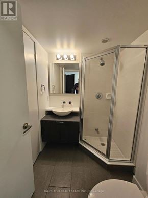 Toronto (Waterfront Communities) condo for rent - A bathroom with a sink, mirror, and shower.