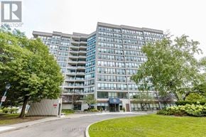 Brampton (Queen Street Corridor) condo for rent - A modern building with glass windows and a sign that reads "HOMELIFE".