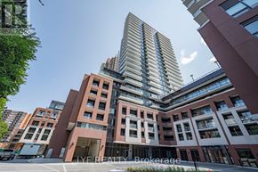 Toronto (Humber Heights) condo for rent - A tall building with a glass facade stands in front of a smaller building with a brick facade.