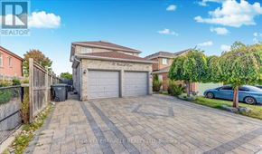 Brampton (Northwood Park) apartment for rent - A residential area with a house, a car, and a garage.